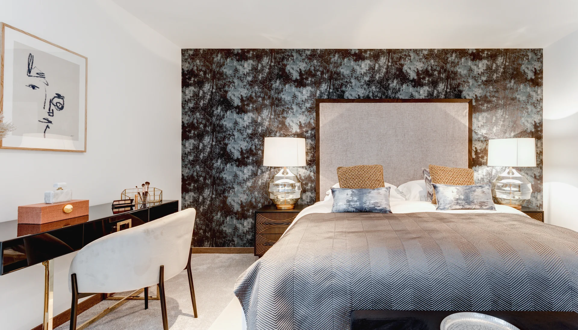 Cozy bedroom featuring a bed with upholstered headboard, stylish lamps, and a contemporary accent wall.