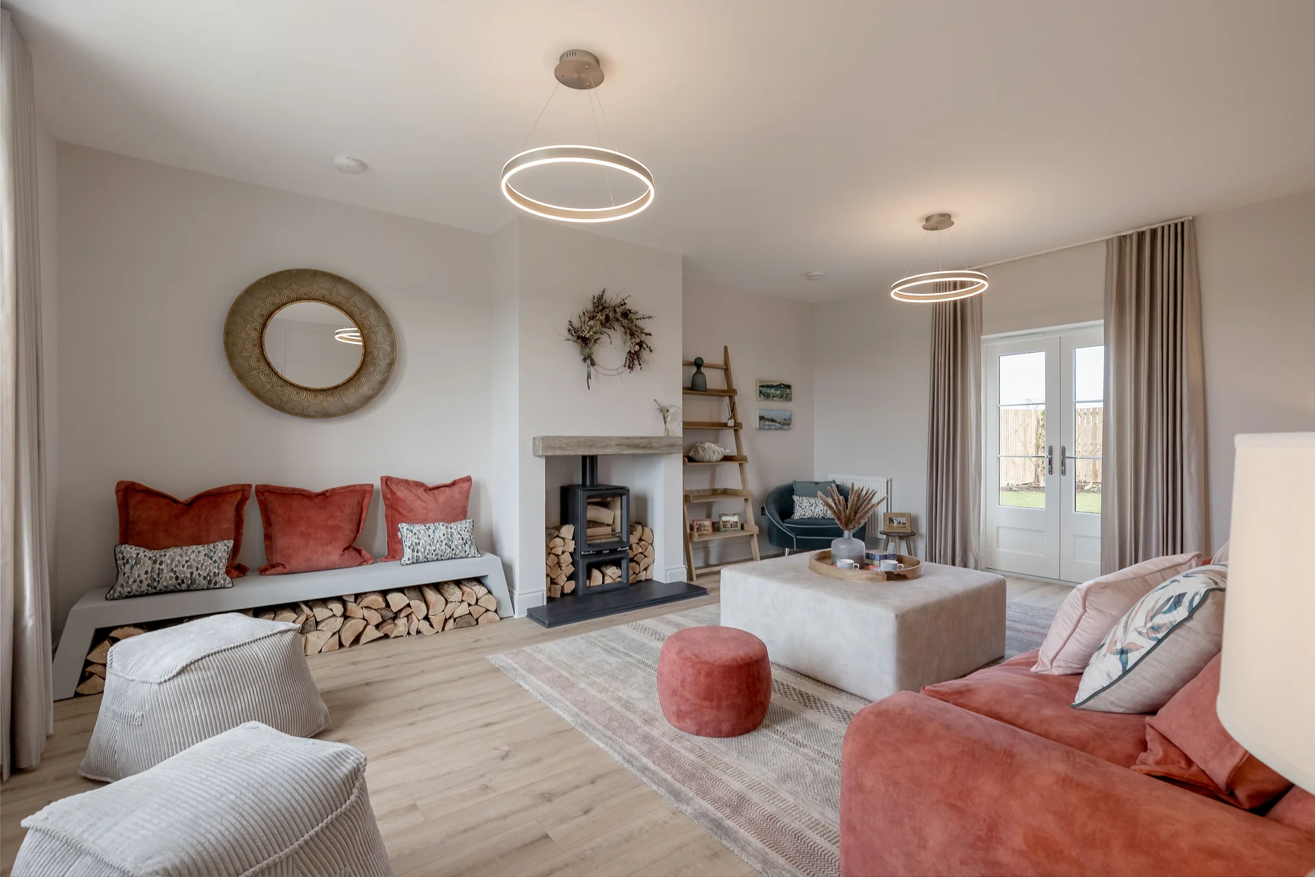 Modern living room featuring a cozy seating area, fireplace, and natural lighting with decorative elements.