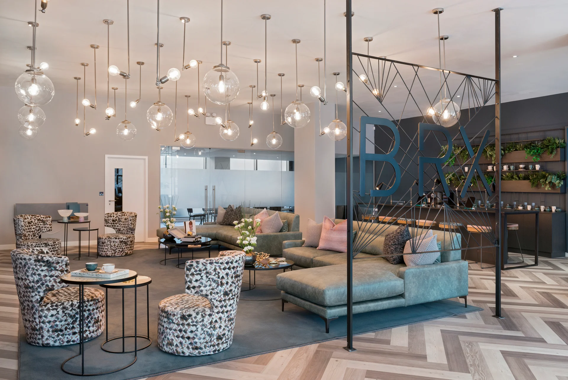 Modern lounge area featuring stylish seating, decorative lights, and a contemporary bar backdrop.