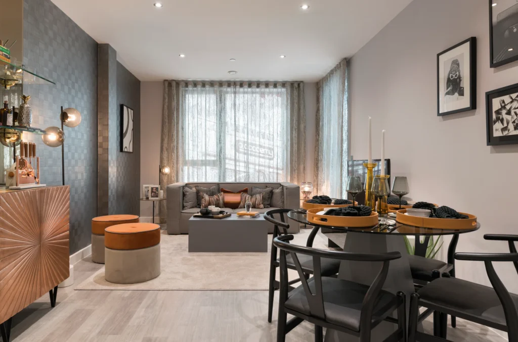 Stylish living space with modern furniture, a dining area, and large windows allowing natural light.