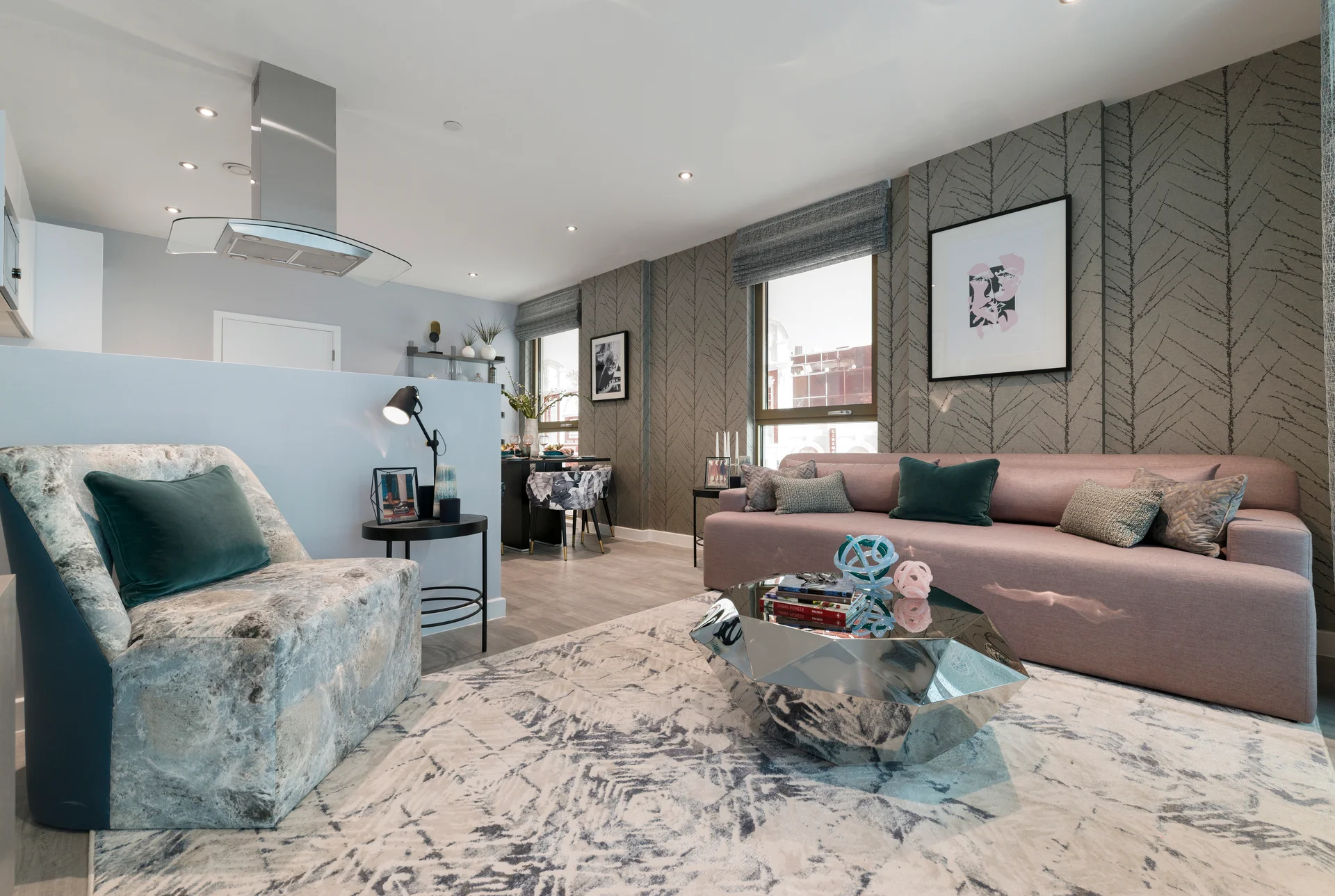 Modern living room with a plush sofa, accent chair, and decorative glass table on a stylish marble floor.